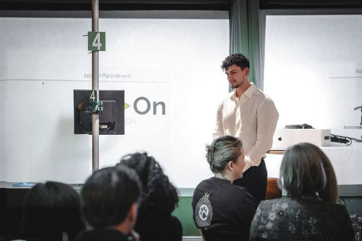 Oscar Cruz, grundare av Leadflix, i vit skjorta, talar inför en grupp företagare